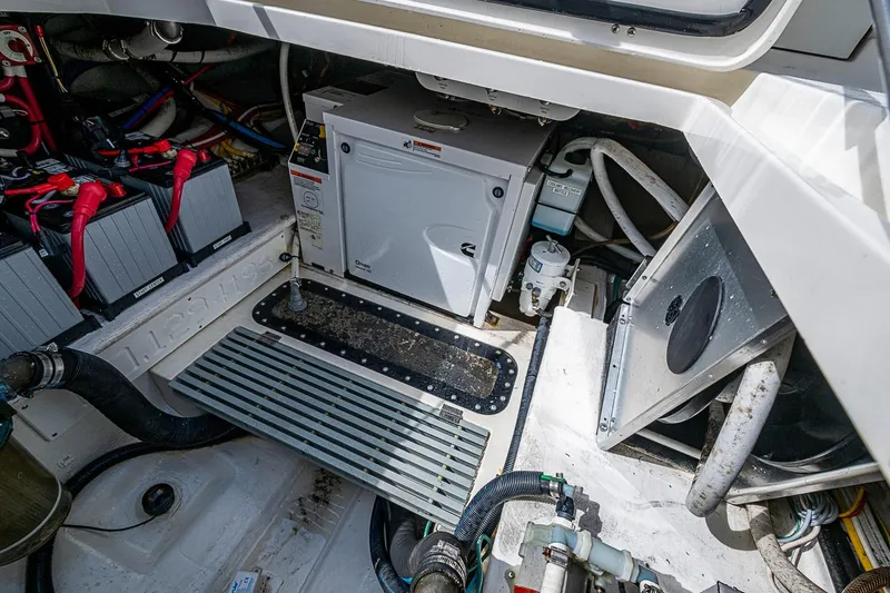 Slide: The Image of Engine compartment of 2019 Hinckley Sport Boat 40 C, showcasing batteries and generator. - 25