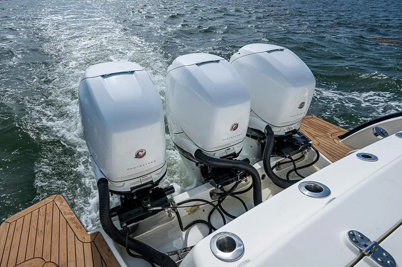 Slide: The Image of 2019 Hinckley Sport Boat 40 C with triple outboard engines on water. - 28