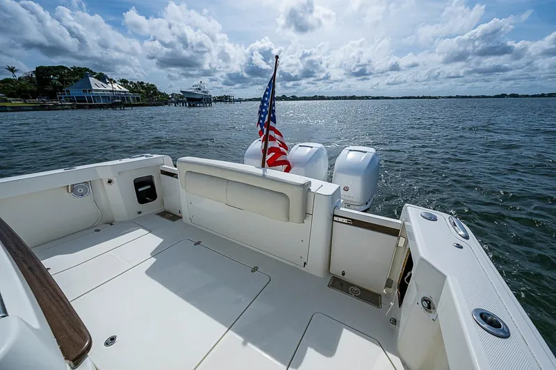 Slide: The Image of Hinckley Sport Boat 40 C, 2019 model, with American flag on open water. - 7