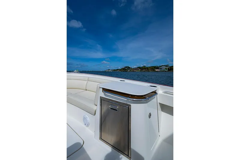 Slide: The Image of 2019 Hinckley Sport Boat 40 C interior with seating, stainless steel accents, and scenic water view. - 9