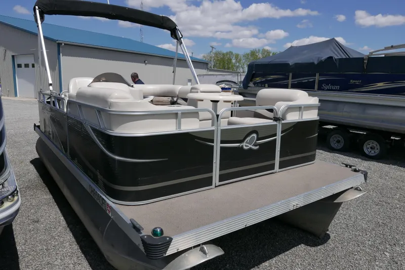 Slide: The Image of 2011 Apex Marine Qwest Adventure 16 pontoon boat with canopy, parked outdoors. - 2