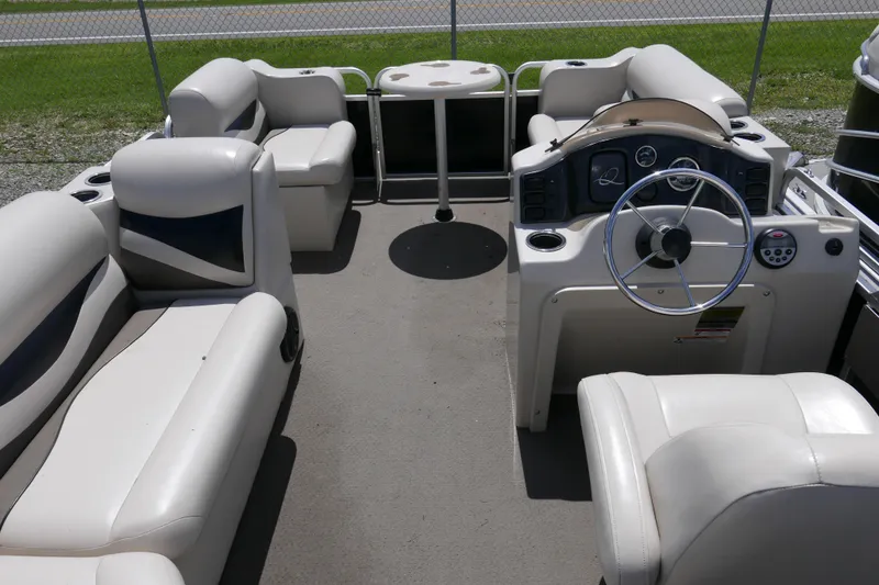 Slide: The Image of 2011 Apex Marine Qwest Adventure 16 pontoon boat interior with seating and steering console. - 9