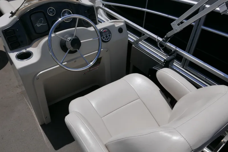 Slide: The Image of Steering console of 2011 Apex Marine Qwest Adventure 16 pontoon boat with white captain's chair. - 10