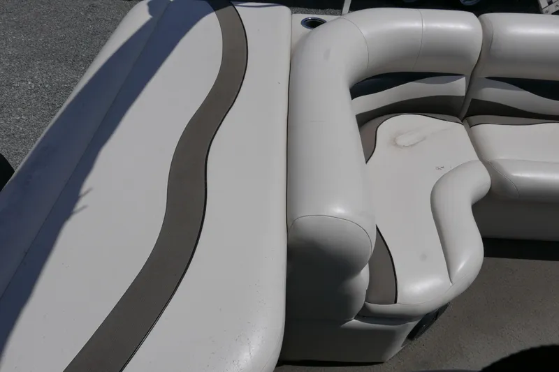 Slide: The Image of 2011 Apex Marine Qwest Adventure 16 boat interior with white cushioned seating. - 13