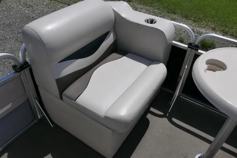 Slide: The Image of 2011 Apex Marine Qwest Adventure 16 boat seat with cup holder and table. - 7