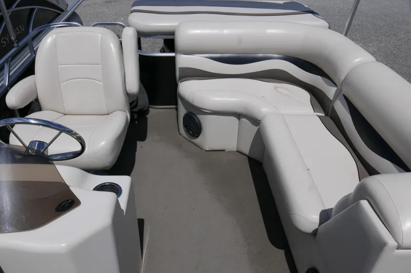 Slide: The Image of 2011 Apex Marine Qwest Adventure 16 interior with white seating and steering wheel. - 8