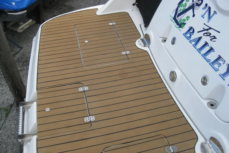 Slide: The Image of 2010 Crownline 330 CR boat deck with teak flooring and custom graphics. - 11