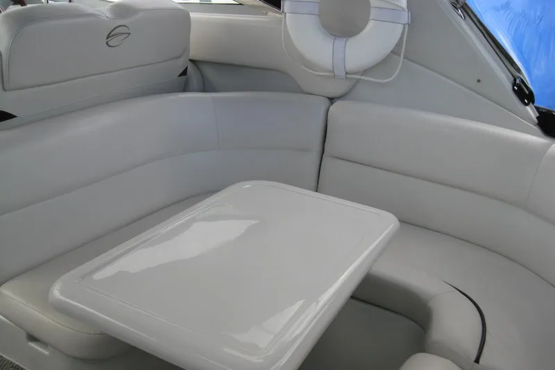 Slide: The Image of 2010 Crownline 330 CR boat interior with white seating and table. - 13