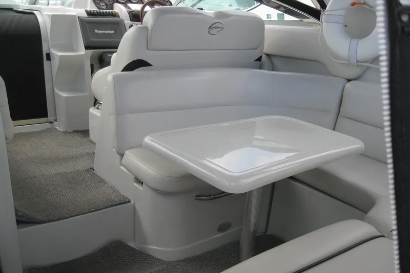 Slide: The Image of 2010 Crownline 330 CR boat interior with seating and table. - 15