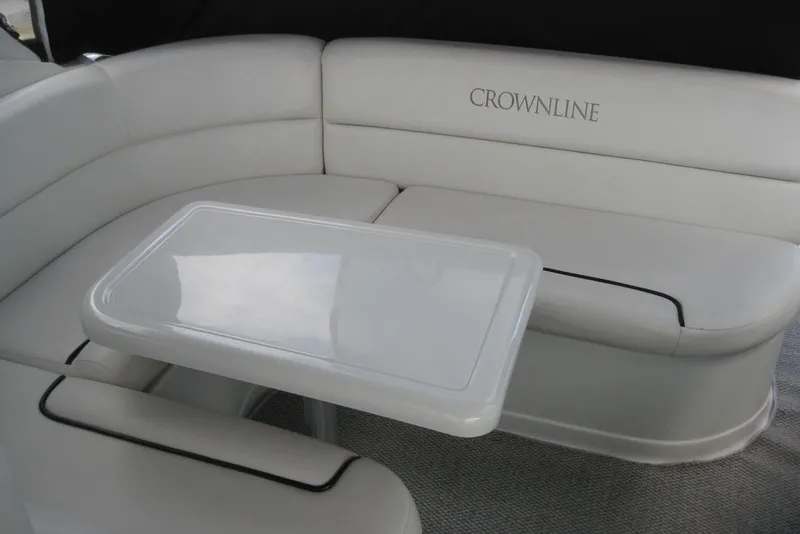 Slide: The Image of 2010 Crownline 330 CR boat interior with white seating and table. - 18
