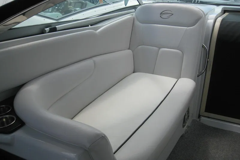 Slide: The Image of Luxurious white seating in 2010 Crownline 330 CR boat interior. - 19