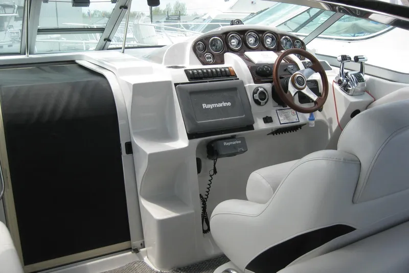 Slide: The Image of Cockpit of 2010 Crownline 330 CR boat with steering wheel and navigation system. - 20