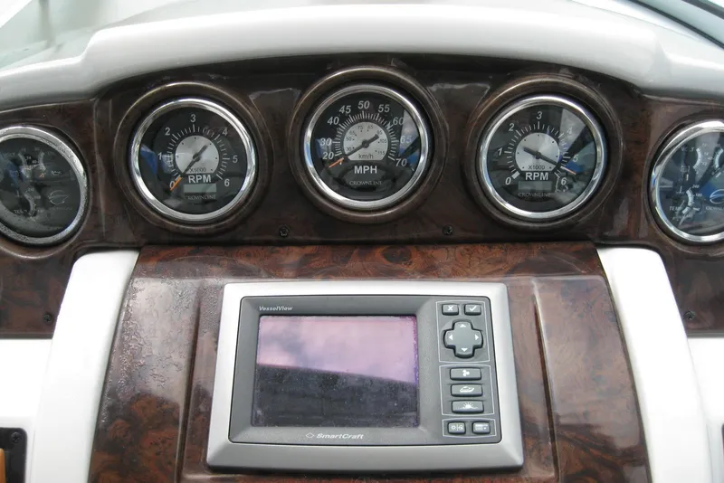 Slide: The Image of Dashboard of a 2010 Crownline 330 CR boat with gauges and a digital display. - 22