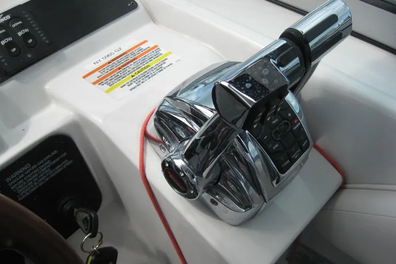Slide: The Image of Close-up of 2010 Crownline 330 CR boat throttle controls with warning labels. - 24
