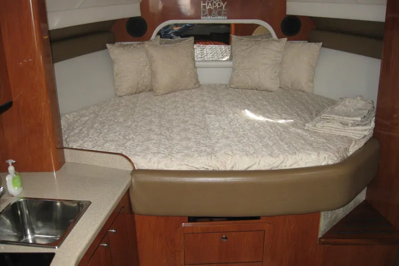 Slide: The Image of Luxurious interior of 2010 Crownline 330 CR boat with cozy bed and wooden cabinetry. - 28
