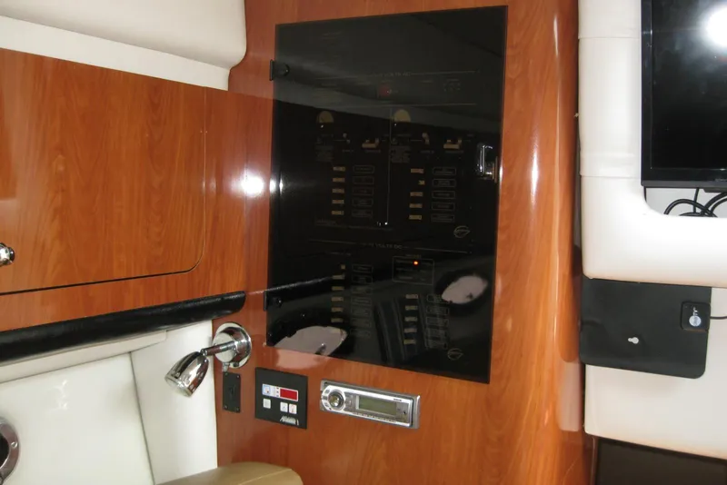 Slide: The Image of Interior control panel of a 2010 Crownline 330 CR boat with wood finish. - 33