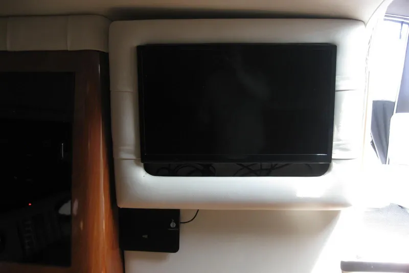 Slide: The Image of Flat-screen TV inside 2010 Crownline 330 CR boat cabin interior. - 34