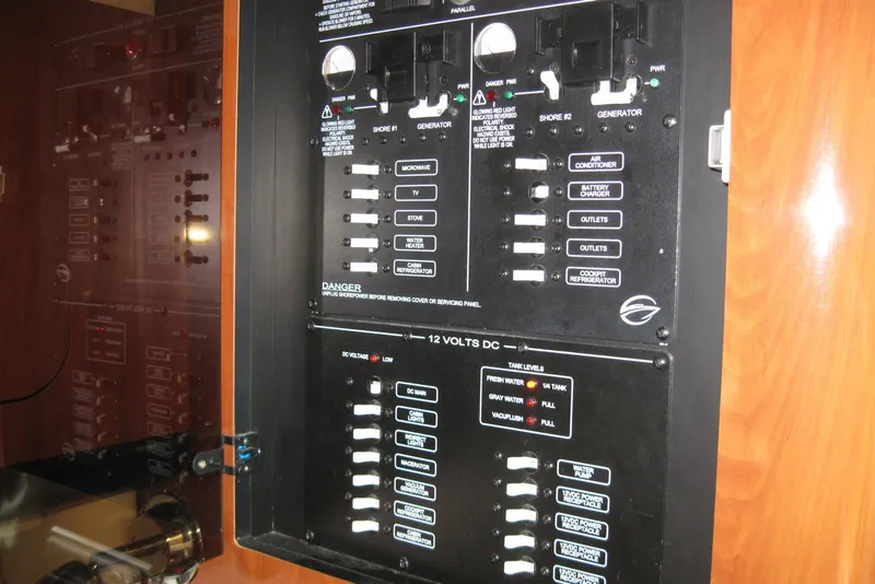 Slide: The Image of Electrical control panel on a 2010 Crownline 330 CR boat, featuring various switches and indicators. - 35