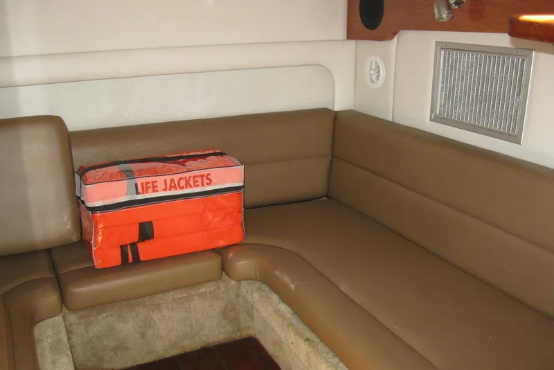 Slide: The Image of Interior of 2010 Crownline 330 CR boat with life jackets on brown seating. - 36
