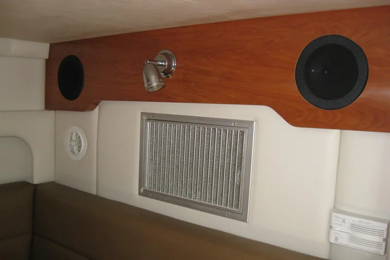 Slide: The Image of Interior of 2010 Crownline 330 CR boat with wood paneling and speaker system. - 37