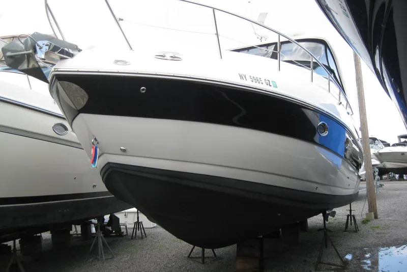 Slide: The Image of 2010 Crownline 330 CR boat on stands, side view, in storage yard. - 4