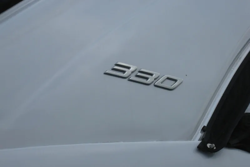 Slide: The Image of Crownline 330 CR 2010 model emblem on a sleek white surface. - 6