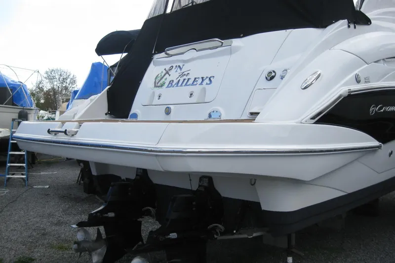 Slide: The Image of 2010 Crownline 330 CR boat with custom name, docked and covered. - 7