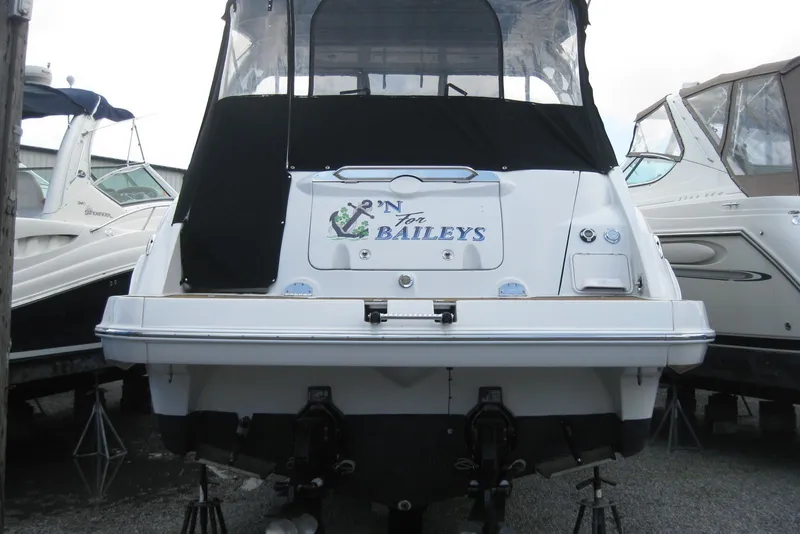 Slide: The Image of 2010 Crownline 330 CR boat with custom name, docked among other vessels. - 8