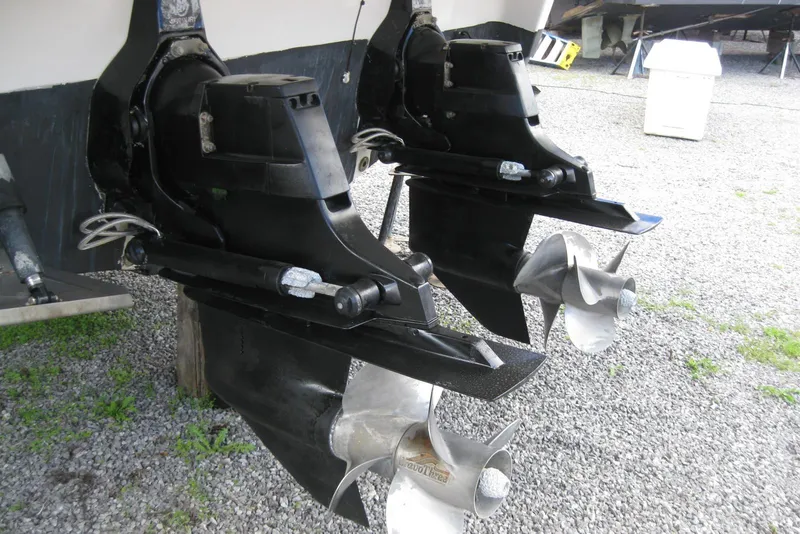 Slide: The Image of Dual propellers of a 2010 Crownline 330 CR boat on gravel surface. - 9