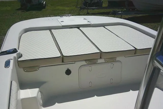 Slide: The Image of 2021 Carolina Skiff 23 LS boat interior with cushioned seating and storage compartments. - 11