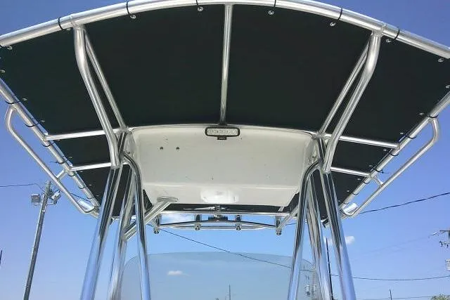 Slide: The Image of 2021 Carolina Skiff 23 LS boat T-top against clear blue sky. - 14