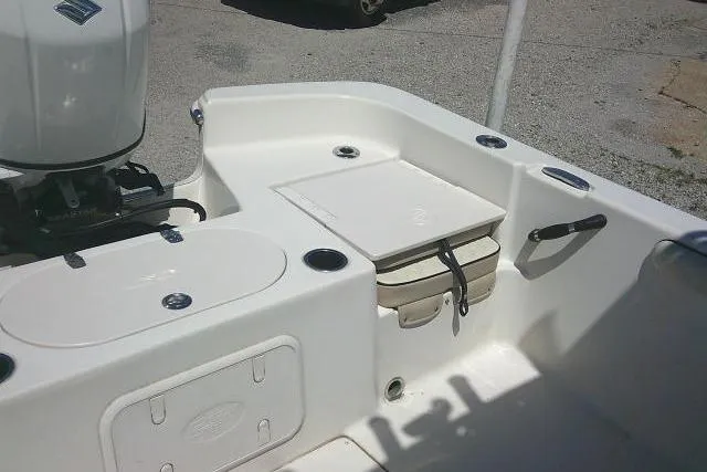 Slide: The Image of 2021 Carolina Skiff 23 LS boat interior with storage compartments and motor. - 20
