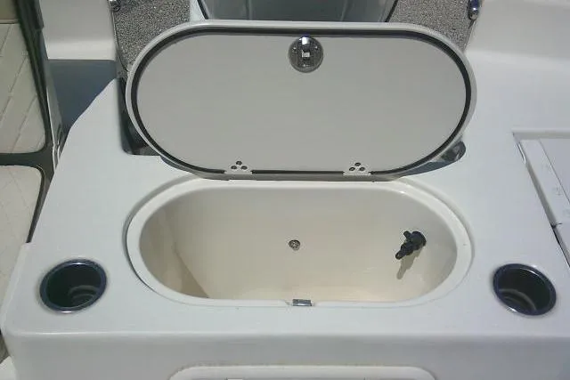 Slide: The Image of 2021 Carolina Skiff 23 LS boat livewell with open lid and cup holders. - 22