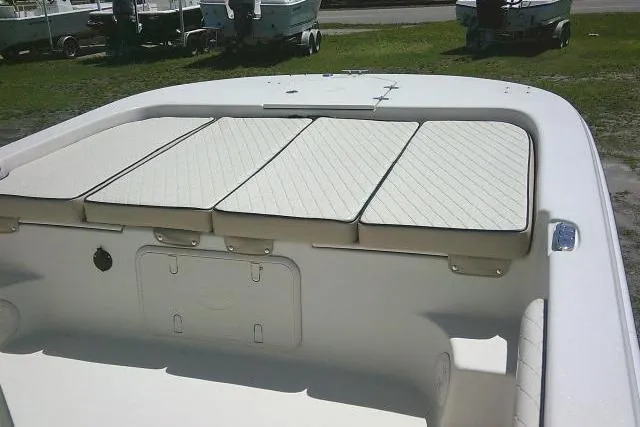 Slide: The Image of 2021 Carolina Skiff 23 LS boat interior with cushioned seating and storage compartments. - 27