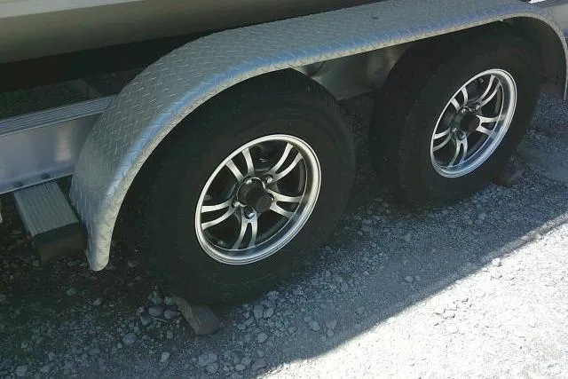 Slide: The Image of Trailer wheels of a 2021 Carolina Skiff 23 LS on gravel surface. - 5