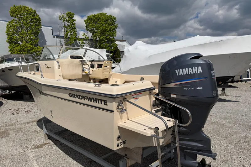 Slide: The Image of 2011 Grady-White Adventure 208 boat with Yamaha engine, parked outdoors on gravel. - 1