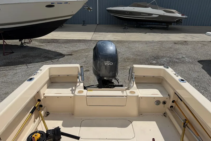 Slide: The Image of 2011 Grady-White Adventure 208 boat with Yamaha 150 engine in a marina setting. - 10