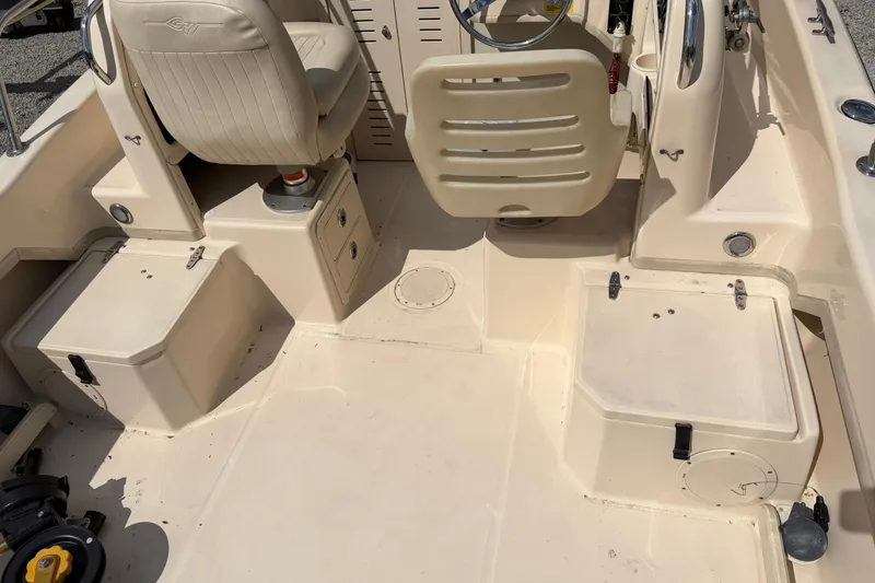 Slide: The Image of Interior of a 2011 Grady-White Adventure 208 boat, featuring seating and storage compartments. - 11