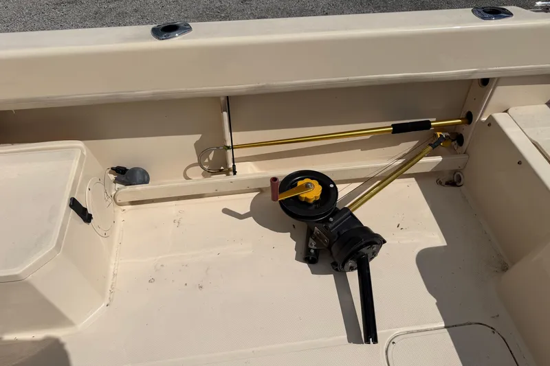 Slide: The Image of Interior of a 2011 Grady-White Adventure 208 boat, featuring fishing equipment. - 12