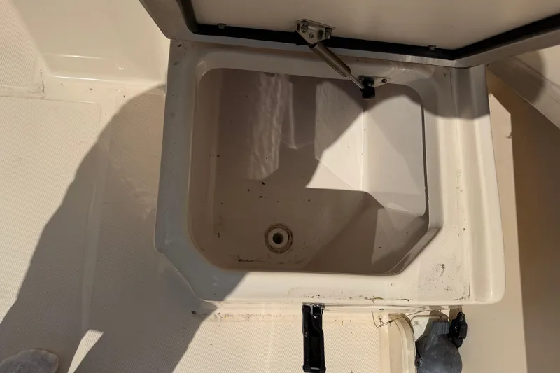 Slide: The Image of Open storage compartment on 2011 Grady-White Adventure 208 boat. - 13