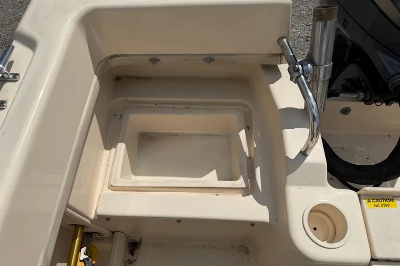 Slide: The Image of Grady-White Adventure 208 boat interior detail, 2011 model, featuring storage compartment and rod holder. - 14