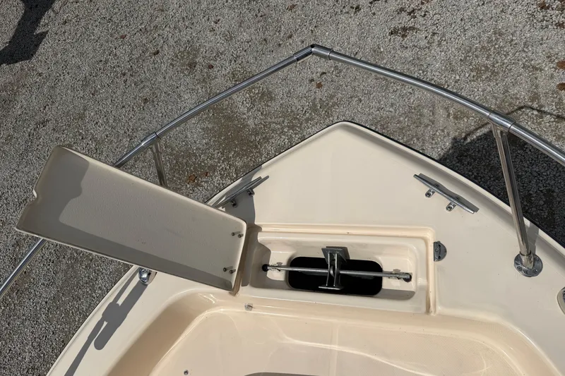Slide: The Image of Bow of 2011 Grady-White Adventure 208 boat with open anchor compartment. - 16