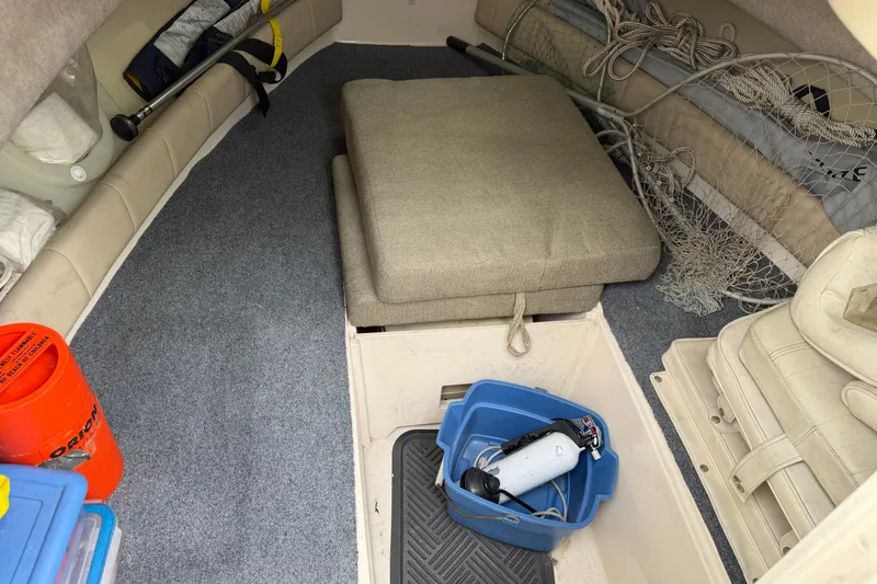 Slide: The Image of Interior of a 2011 Grady-White Adventure 208 boat with fishing gear and storage. - 18