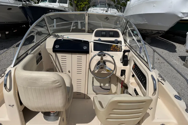 Slide: The Image of Interior view of 2011 Grady-White Adventure 208 boat cockpit with steering wheel and seating. - 4