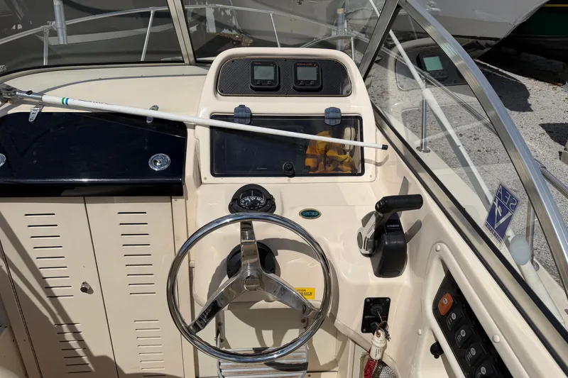 Slide: The Image of Grady-White Adventure 208 boat dashboard with steering wheel and controls, 2011 model. - 5