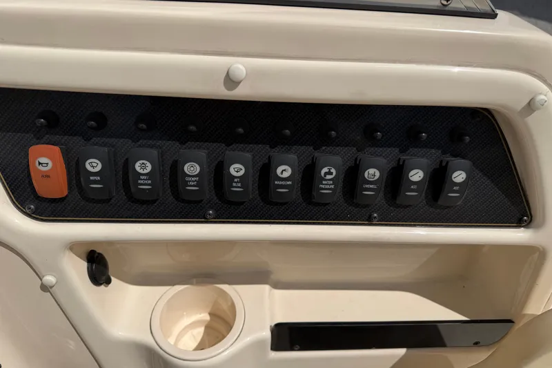 Slide: The Image of Control panel of a 2011 Grady-White Adventure 208 boat with labeled switches. - 9