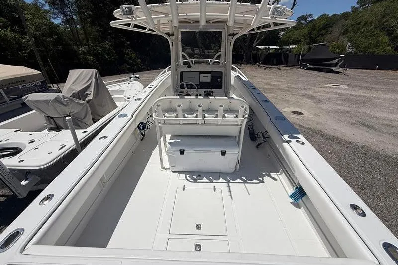 Slide: The Image of 2003 Jupiter 31 Cuddy boat interior with helm, rod holders, and storage. - 10