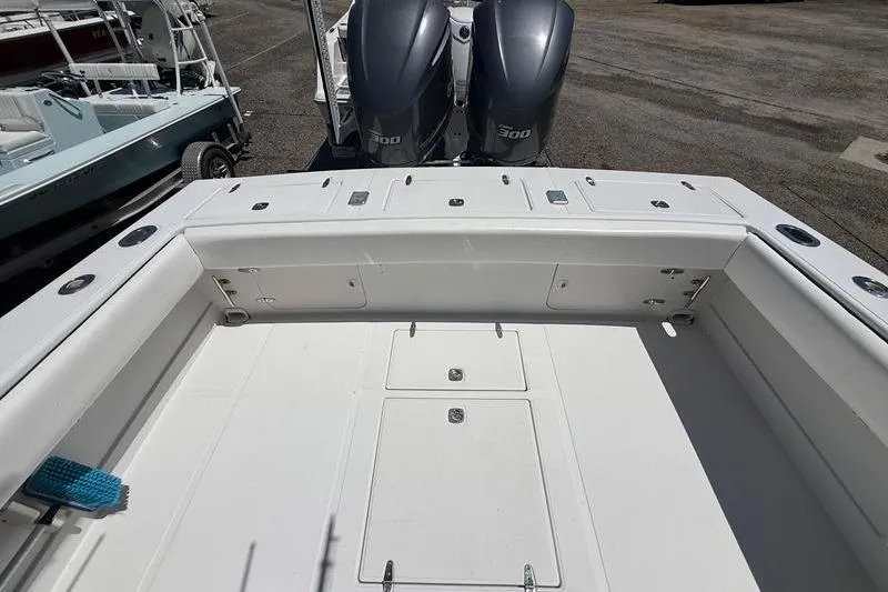 Slide: The Image of 2003 Jupiter 31 Cuddy boat deck with twin 300 horsepower engines. - 12