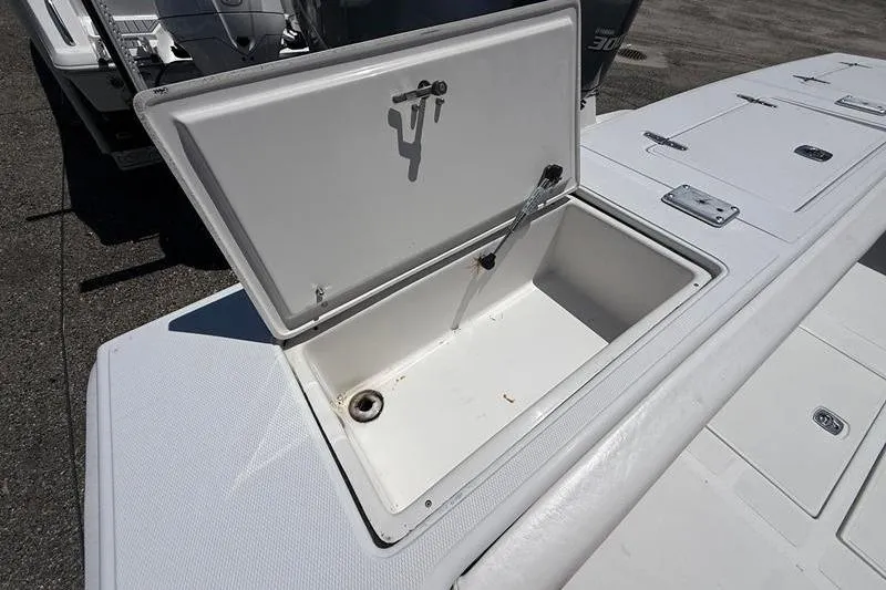 Slide: The Image of Open storage compartment on a 2003 Jupiter 31 Cuddy boat deck. - 13