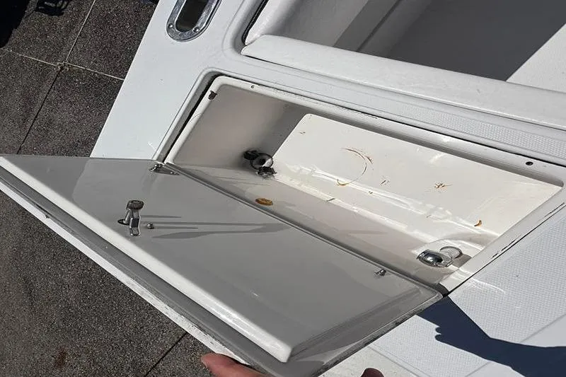 Slide: The Image of Open storage compartment on a 2003 Jupiter 31 Cuddy boat. - 15